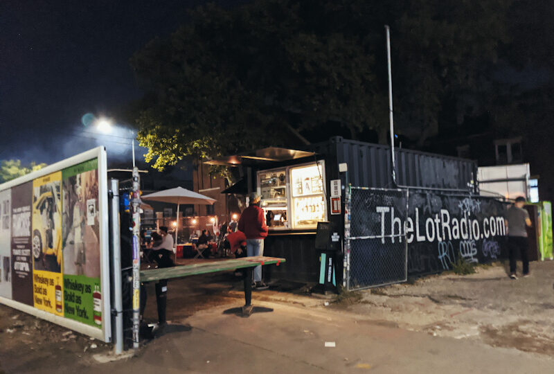 People at a bar made out of shipping containers.