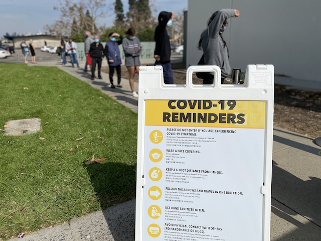 Sign listing COVID-19 safety reminders for voters