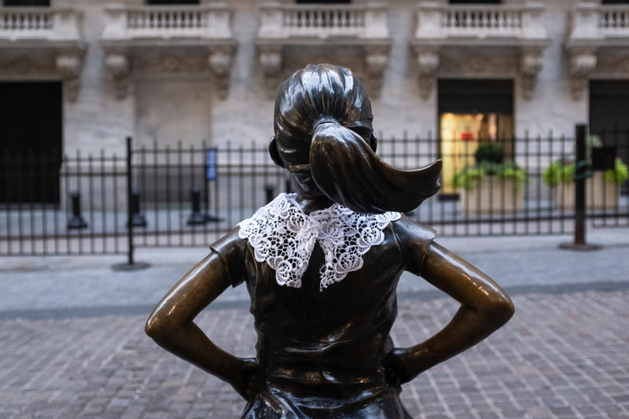 NEW YORK, NEW YORK - September 22, 2020: The 'Fearless Girl' statue by Kristen Visbal in front of the New York Stock Exchange wearing a lace collar in tribute to Justice Ruth Bader Ginsburg. Photo by Jennifer M. Mason