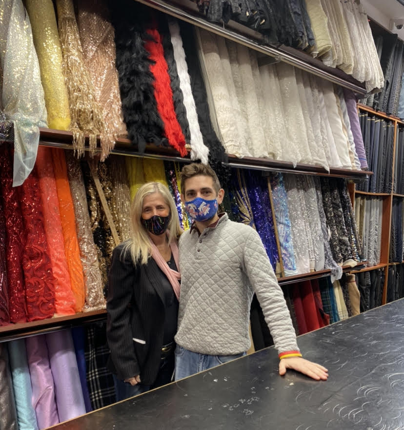 Tricia Fleishman and her son, Joshua, stand among colorful fabrics at their fabric store, Fleishman Fabrics, located on historic Fabric Row.