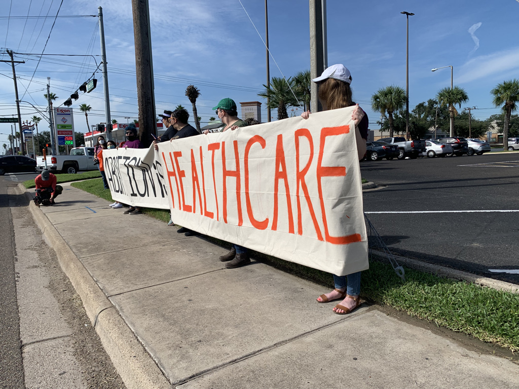 People hold posters saying "Abortion is Healthcare"