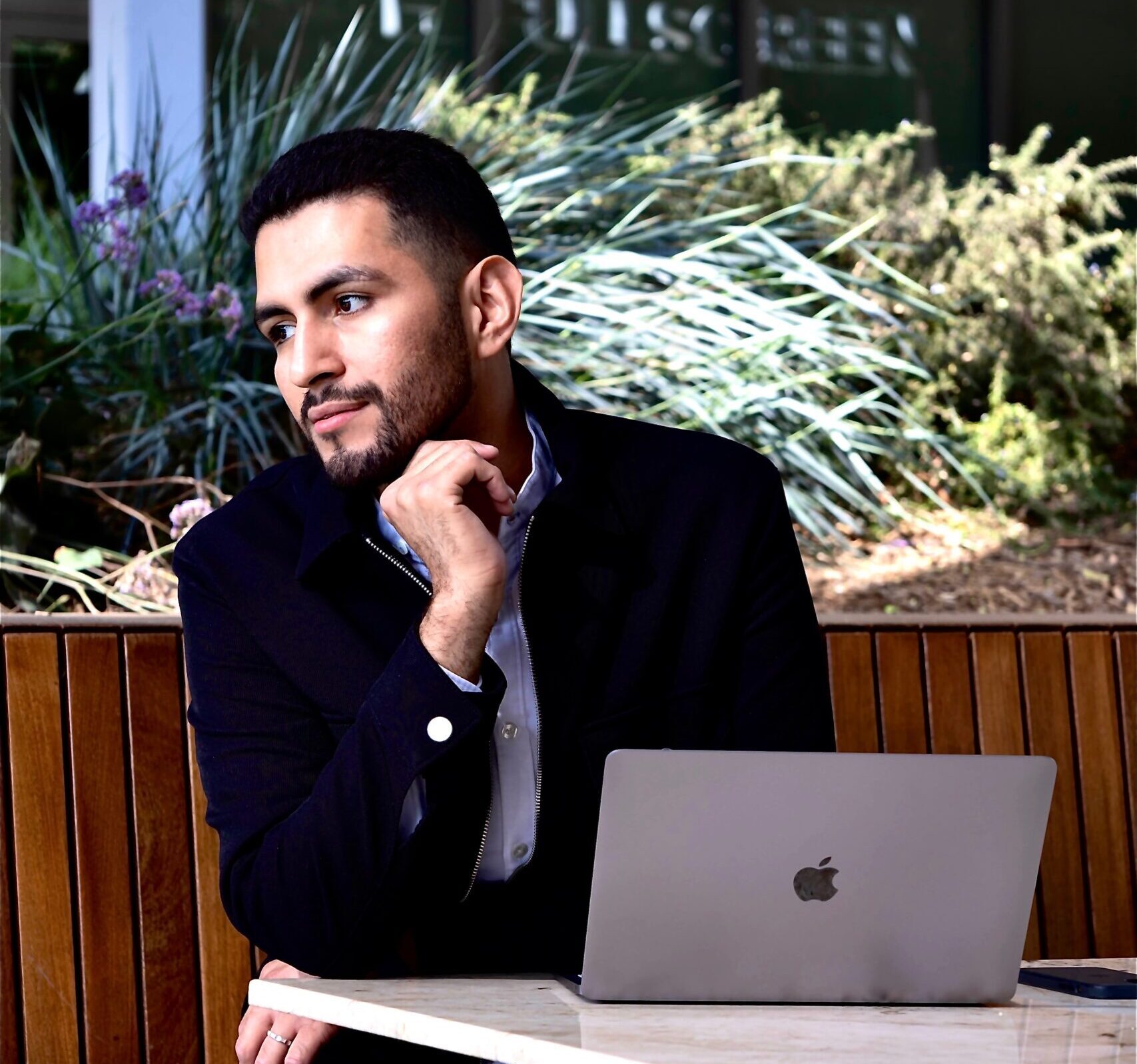 Los Angeles stylist Alec Lopez pictured sitting in from of his laptop working