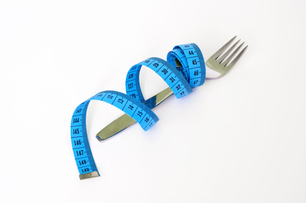 Measuring tape and fork stock photo