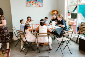 A table full of kids working on activities at a wedding