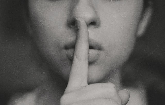 a woman with her finger of her mouth