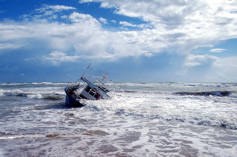 A boat on its side in the ocean