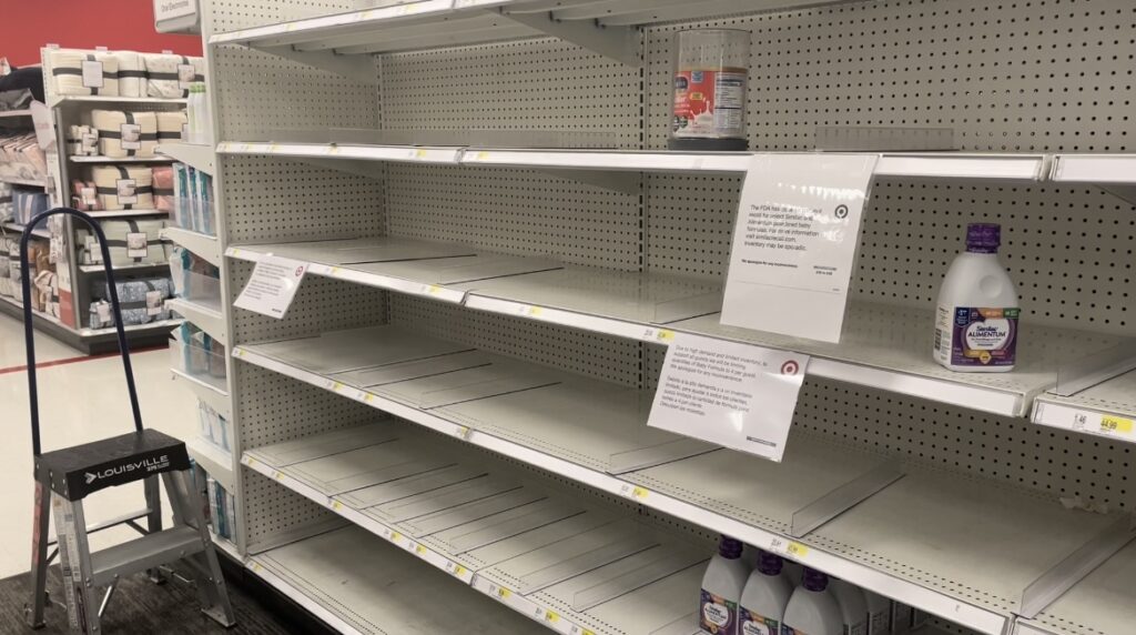 Empty shelves where baby formula is normally stocked