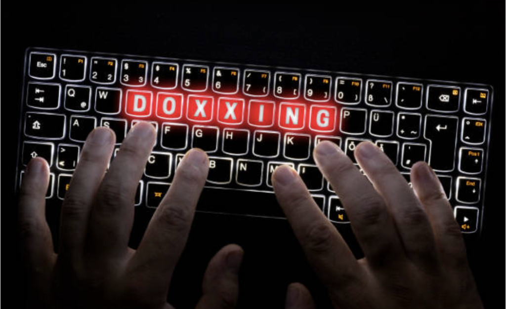 a keyboard that reads "doxxing"