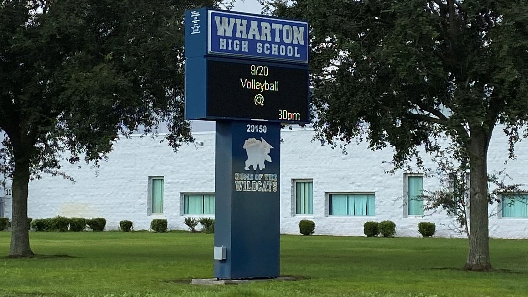 A Wharton High School sign in front of the school.