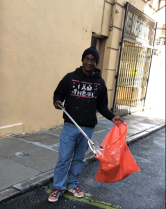 Volunteer Amos Lee Gregory keeping the sidewalk clean next to Fifth Church of Christ, Scientist