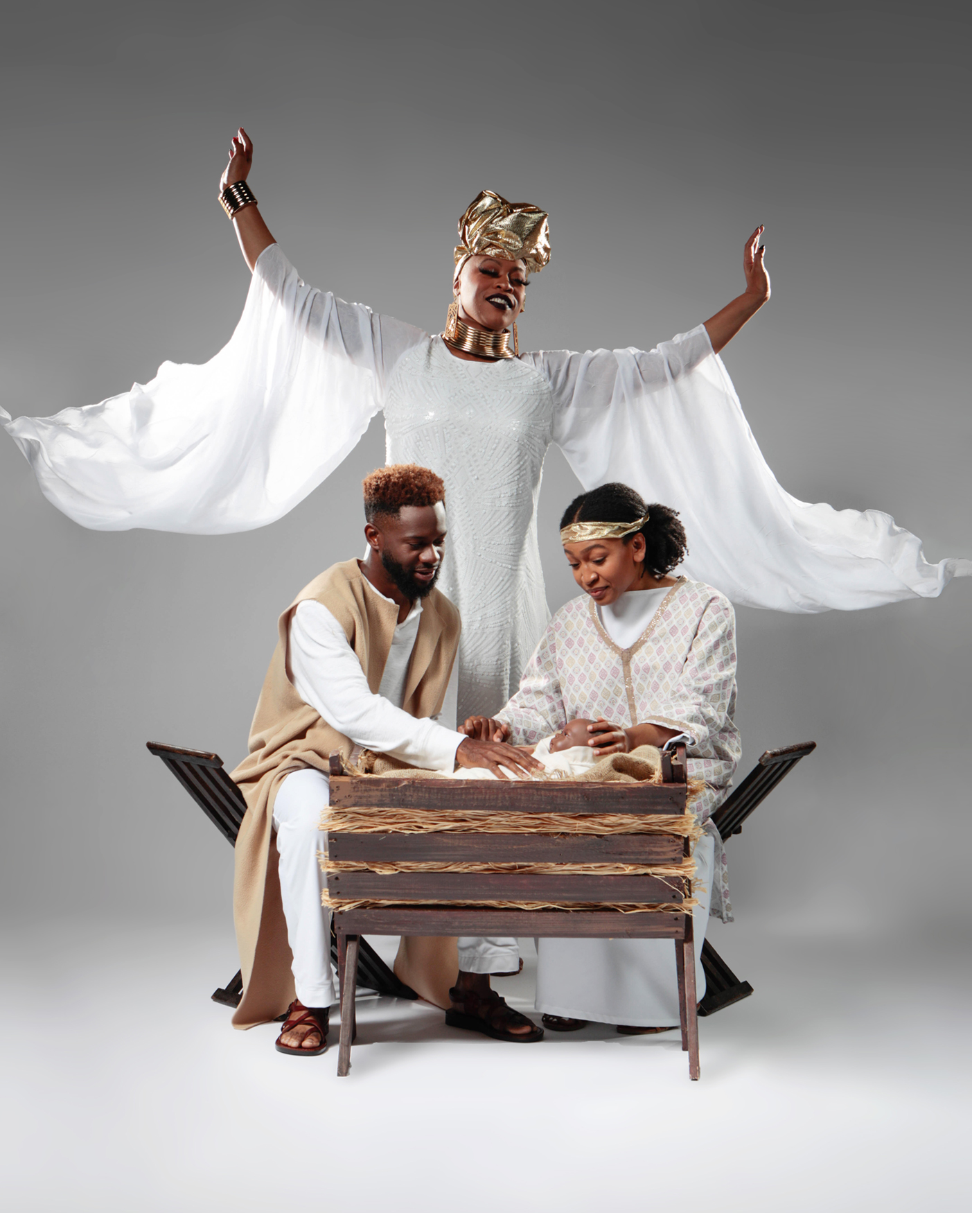 Raleigh Moseley and Maicy Powell pose for Black Nativity photoshoot. They are wearing their costumes dressed as Joseph and Mary.
