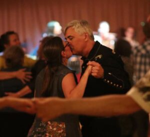 Man and woman kissing on the dance floor