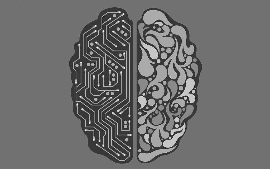 Computer generated image of a brain in two halves. One half is made up of a computer circuit.
