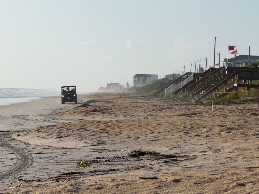 Local volunteers and scientists motor in an all-terrain vehicle along an 11-mile stretch of coast in New Smyrna Beach, Florida, monitoring sea turtle nests. (Credit: Jennifer Taylor)