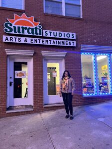 Rimli Roy of Surati Studios standing outside of the front entrance of the studio.