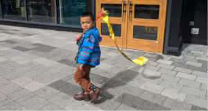 Picture of young Asian boy wearing American flag cowboy boots