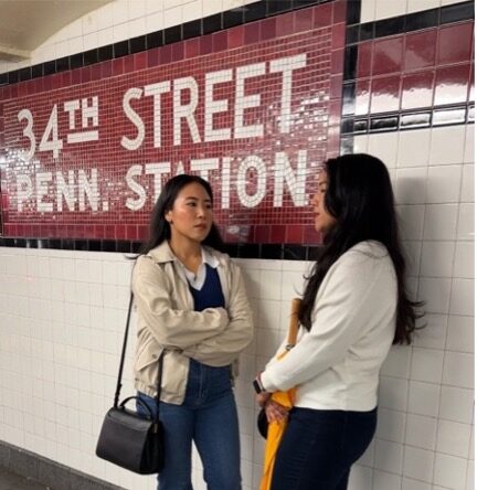 Two Asian American women standing by the subway in New York City