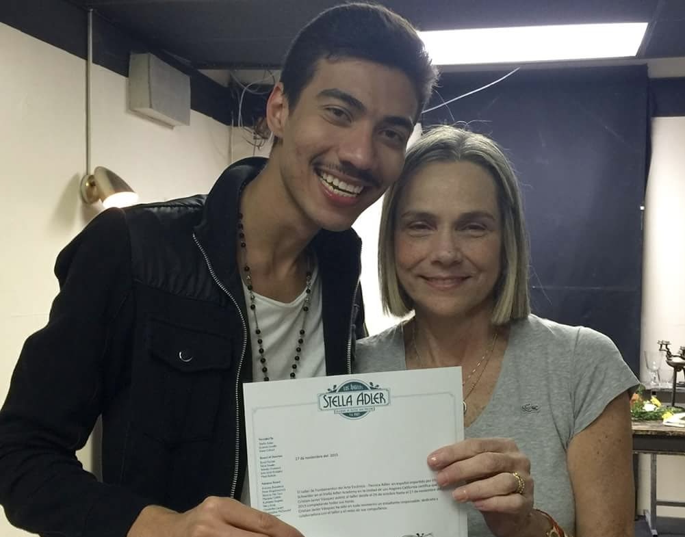 Two smiling, beautiful people holding up a certificate.