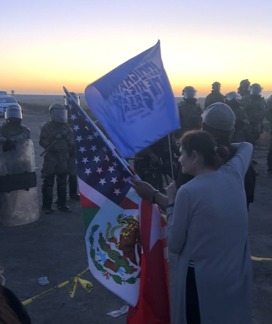 Protesters stand in front of National Guard members.
