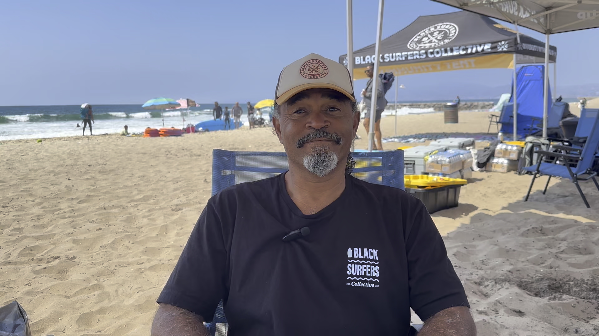 Gregory Rachal sits on beach
