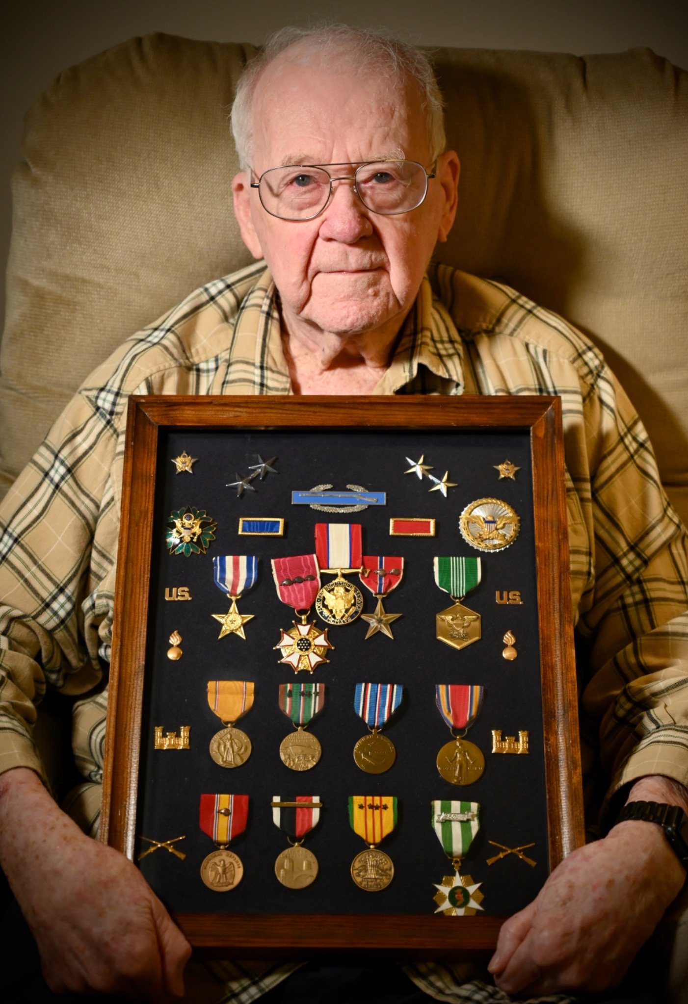 Raaen holds medals from his military career, culminating in his recent award of the Congressional Gold Medal.