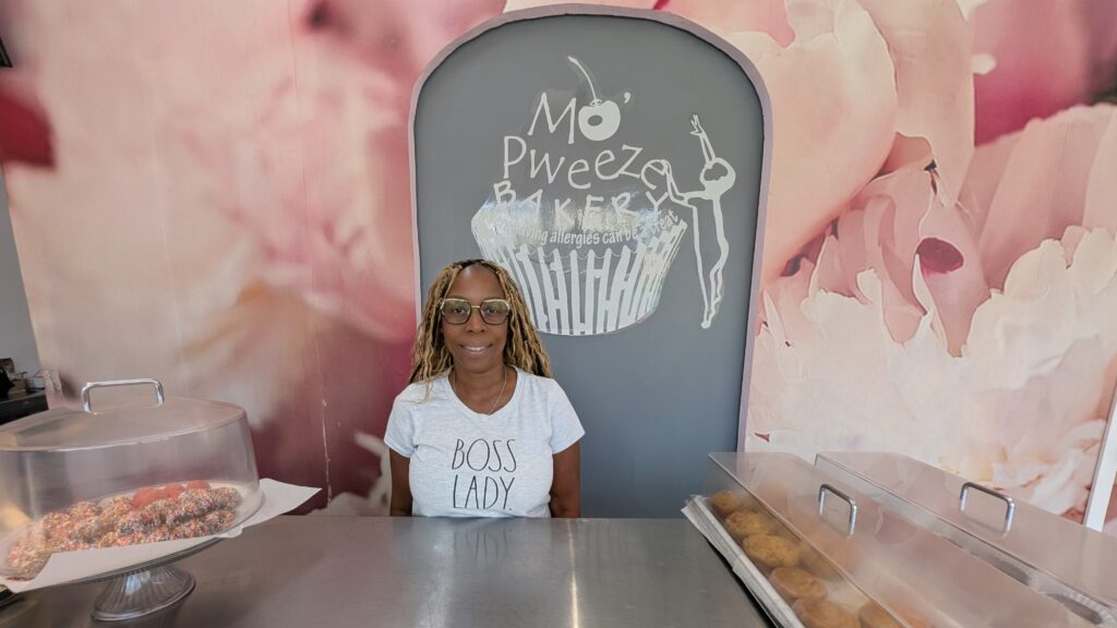 The owner of a bakery in Rockaway stands behind the counter.