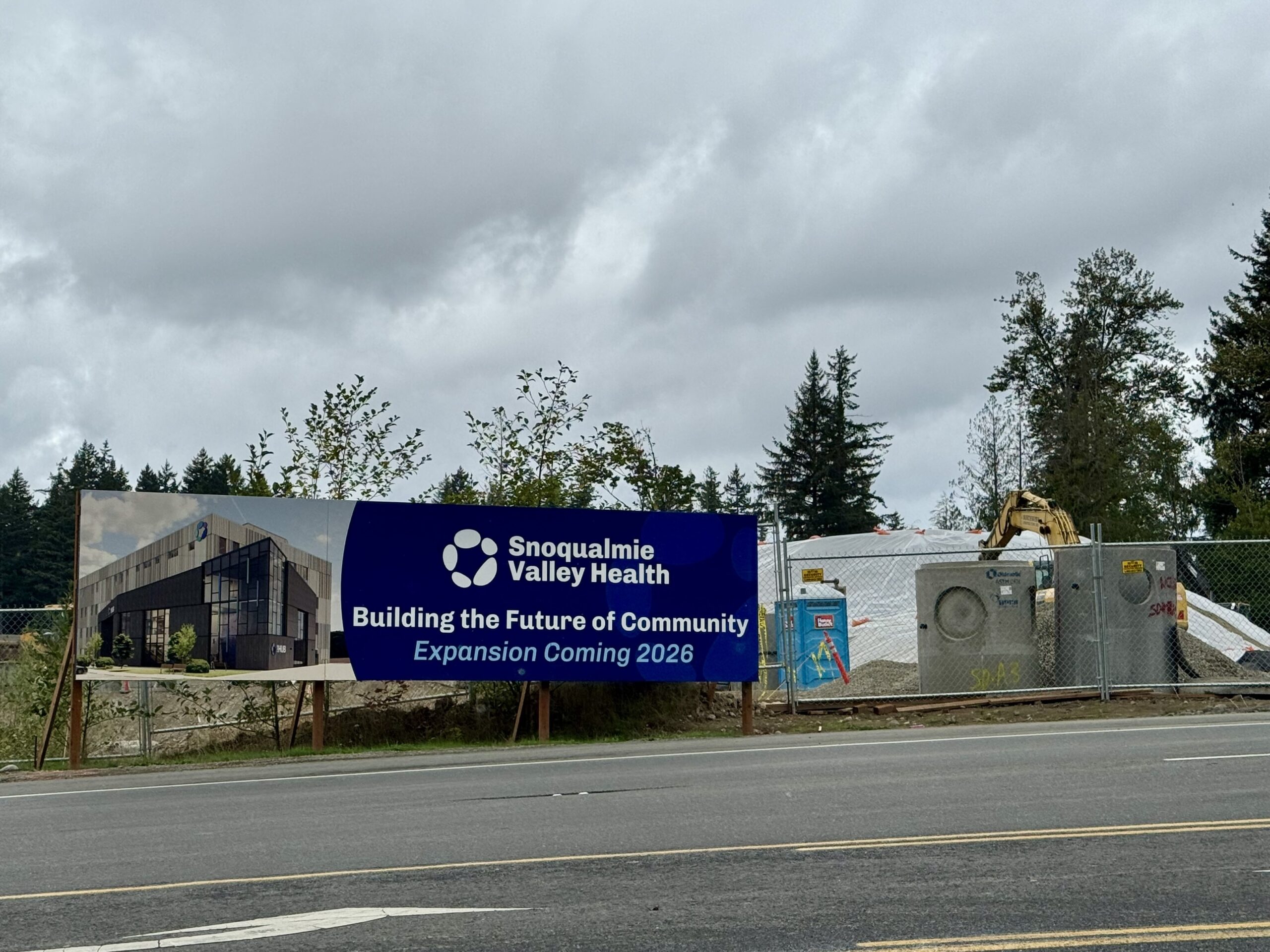 Snoqualmie Valley Health "Building the Future of Community, Expansion Coming 2026" sign at construction site.