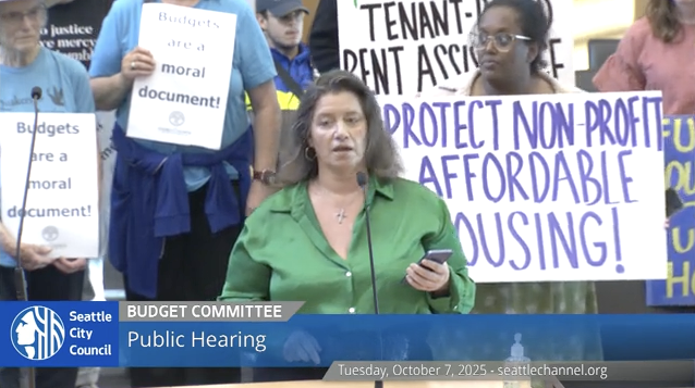 Woman speaks into microphone