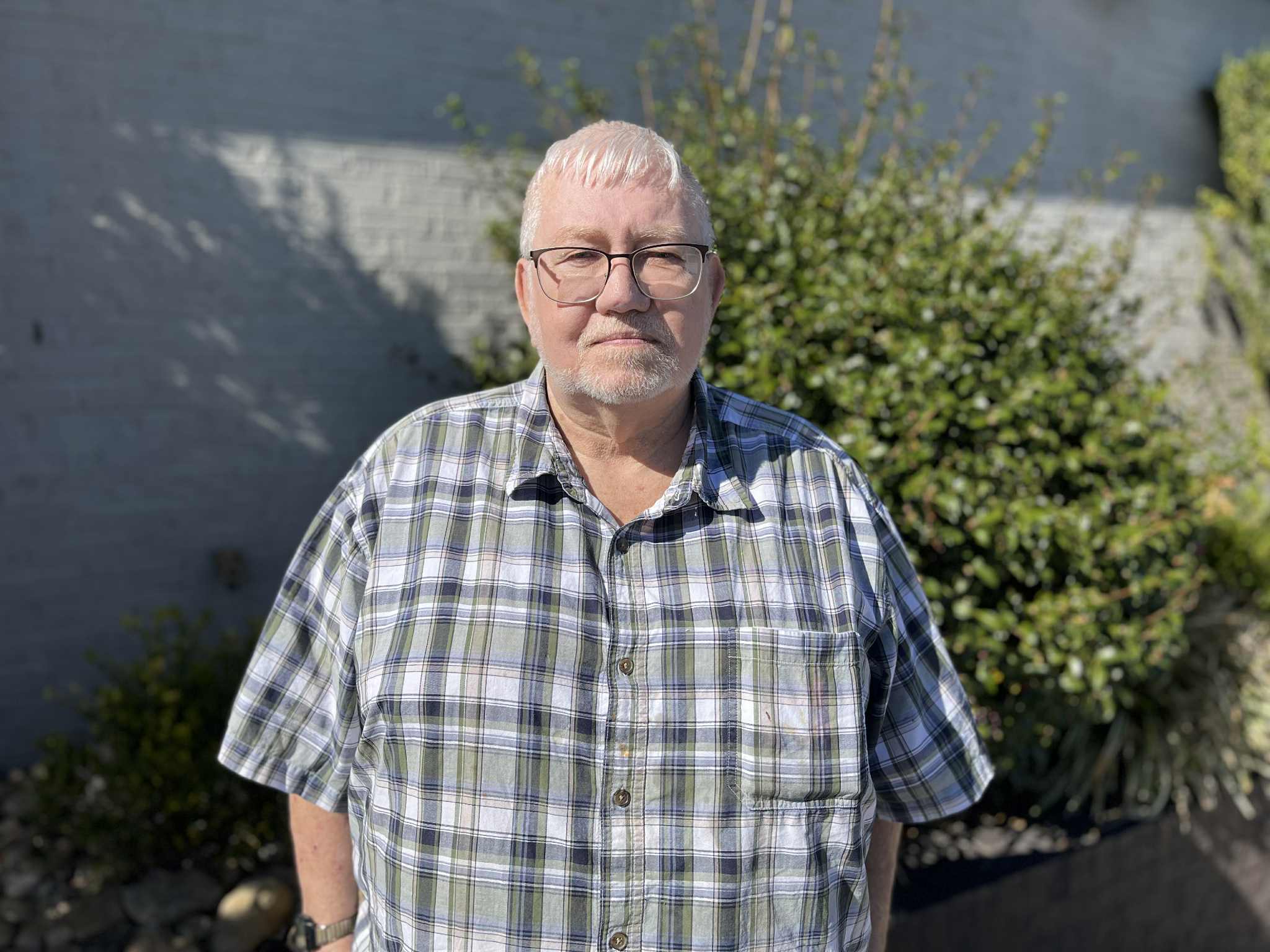 Tom Andrews posing in front of AJ's Steakhouse