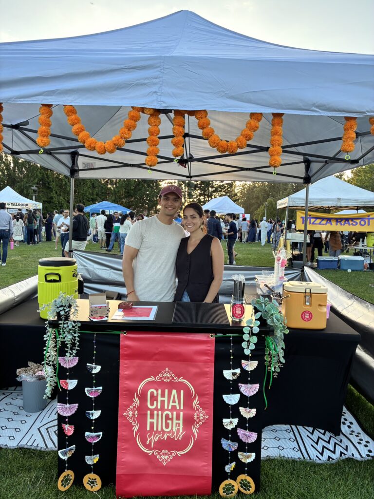 Man and woman smile at farmers market stand
