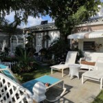Thaddeus Bethel's front yard is well-adorned, with old-style patio furniture and diverse flora. It is a welcome spot for chats with neighbors.
