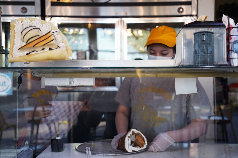 Abigail Vega, store manager, rolls a crepe dessert at Hana Banana, a local dessert spot, in El Paso, Texas, March 10, 2022.