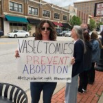 One woman holds a sign saying "vasectomies prevent abortion"