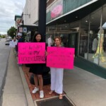 Two women hold pink signs at Roe v Wade rally